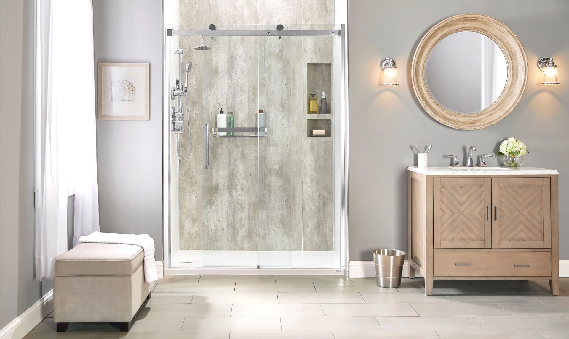 A straight-on photo of a gray and white bathroom with a Lifestyle Wall Farm Deluxe shower stall with doors. A brown vanity and mirror are off to the right.