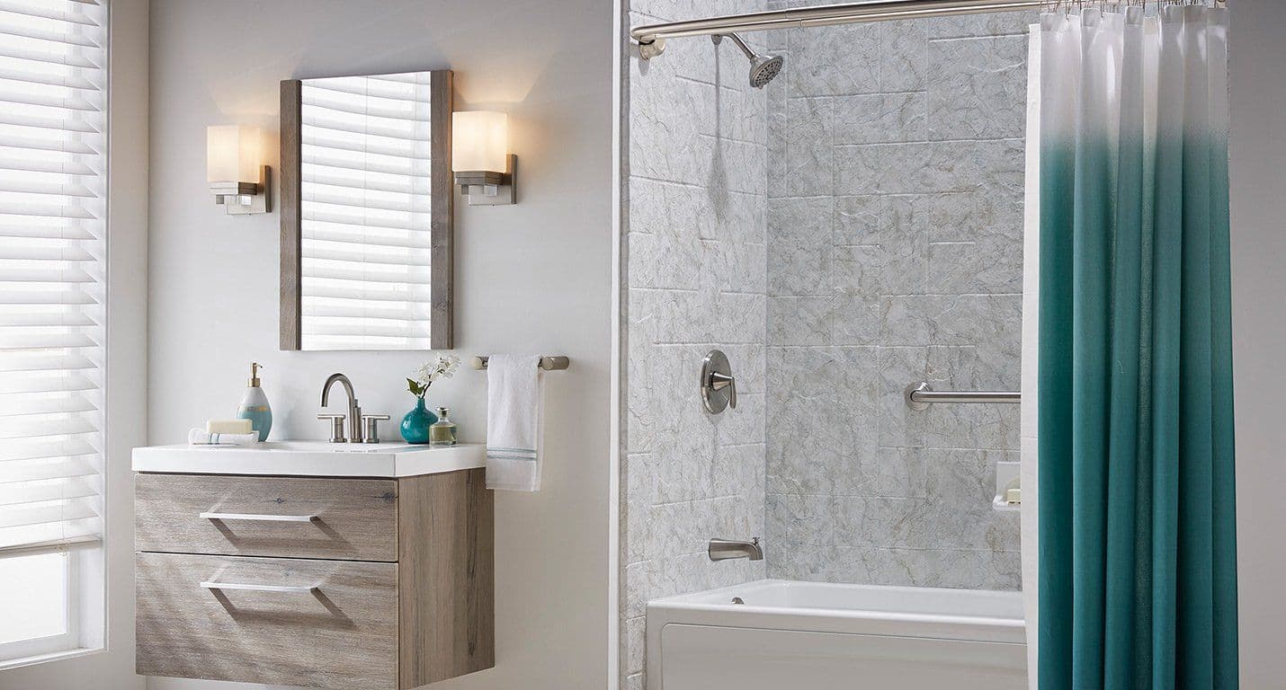 A photo of the BathWraps Venture Breccia tub and shower combination, with a teal shower curtain.