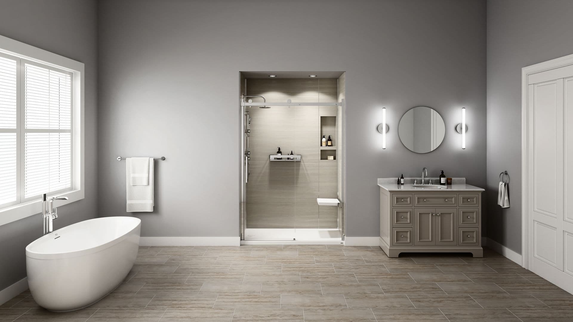 A wide shot of a gray bathroom with a large soaking tub on the left and a Canyon Walls shower with a seat, shelves, and sliding doors.