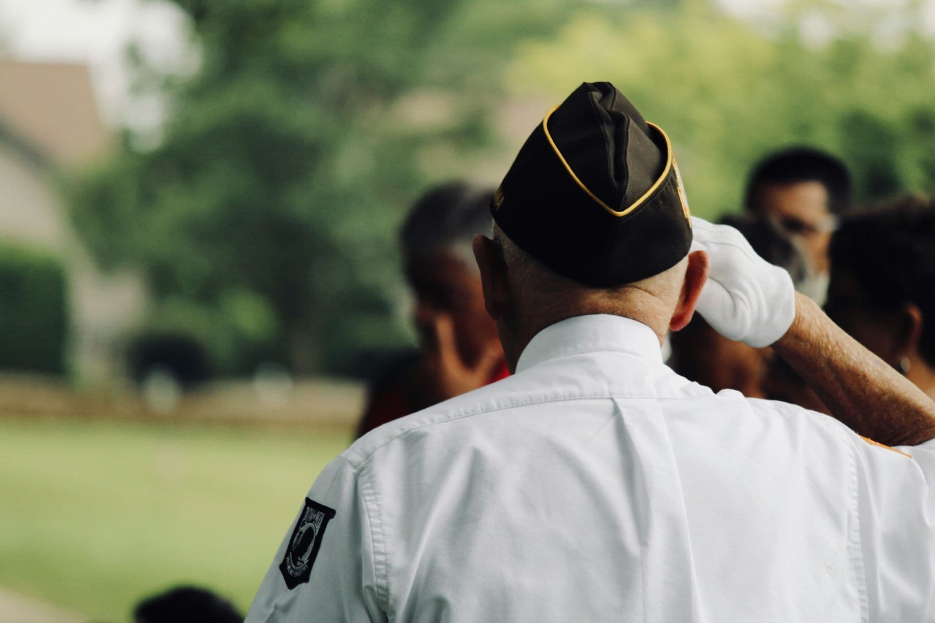 A veteran saluting, facing away from camera